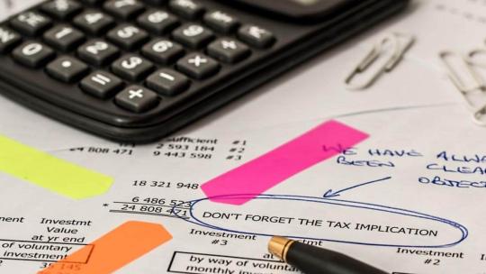 Calculadora encima de papeles de trabajo
